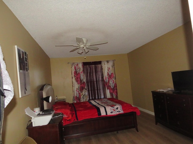 bedroom with hardwood / wood-style floors, a textured ceiling, and ceiling fan