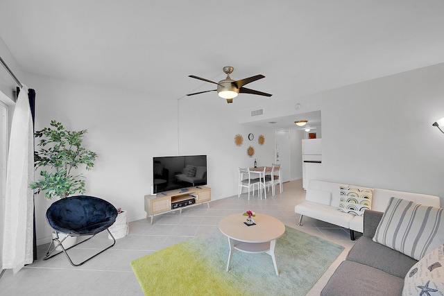 tiled living room with ceiling fan