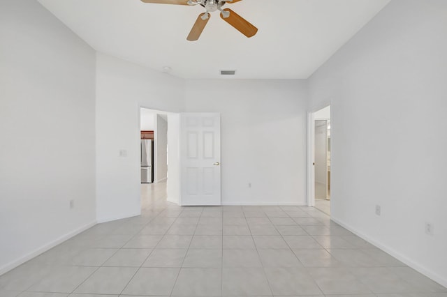 unfurnished room with light tile patterned floors and ceiling fan