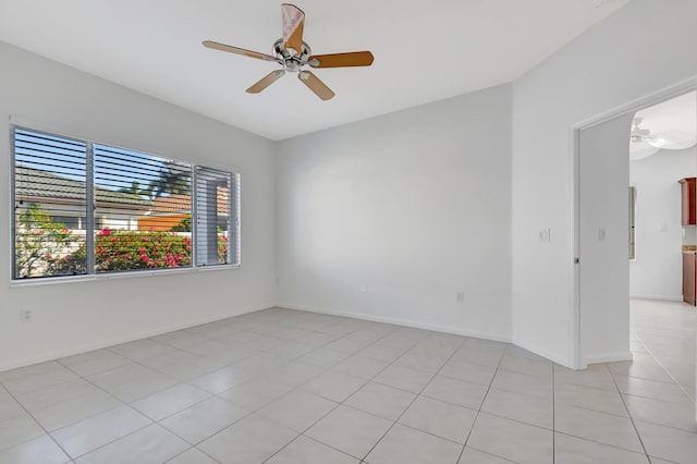 tiled empty room with ceiling fan