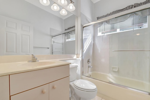 full bathroom with toilet, vanity, and shower / bath combination with glass door