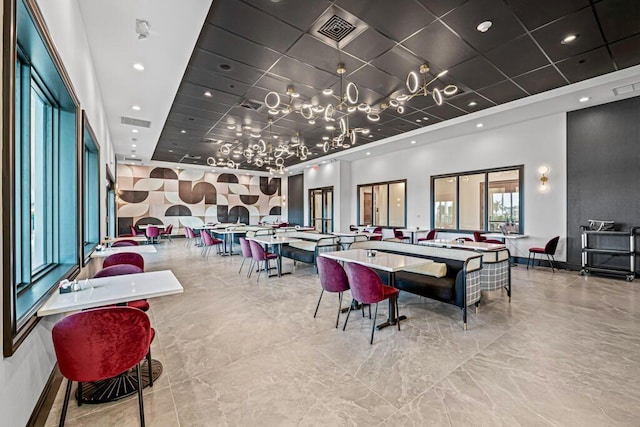 recreation room featuring a towering ceiling