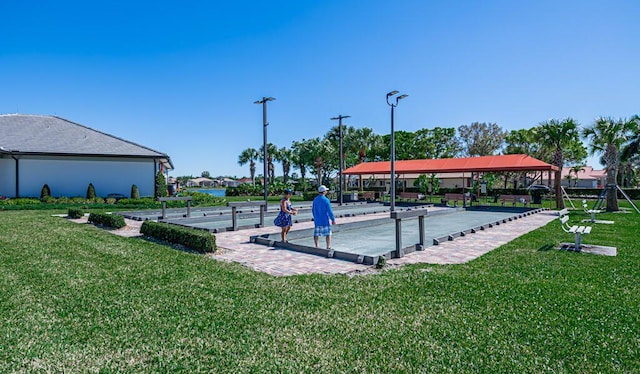 view of home's community with a yard