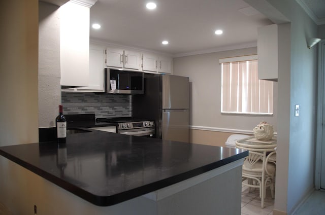 kitchen with appliances with stainless steel finishes, white cabinetry, backsplash, ornamental molding, and kitchen peninsula