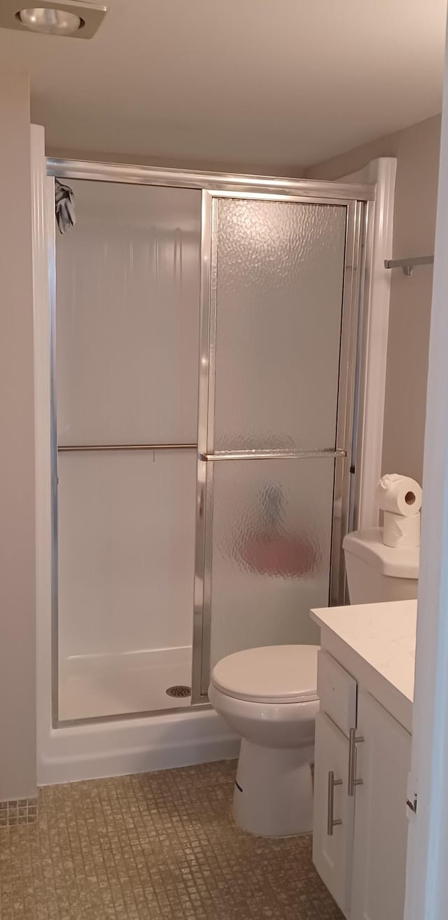 bathroom featuring vanity, toilet, and walk in shower