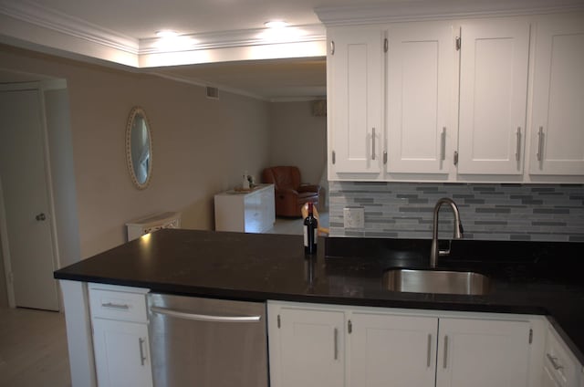 kitchen with white cabinetry, sink, and ornamental molding