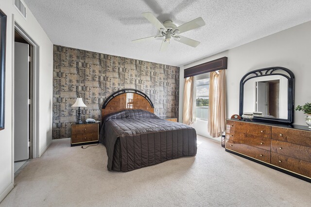 living room with light tile patterned flooring, ceiling fan, and a textured ceiling