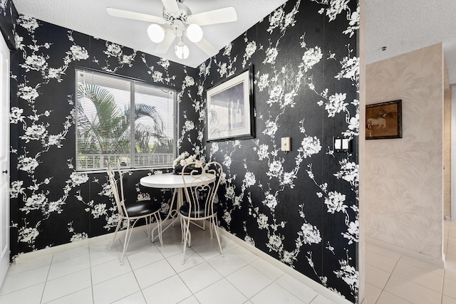 tiled dining space featuring ceiling fan and a textured ceiling