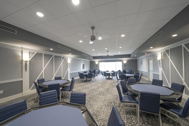 miscellaneous room with a paneled ceiling, ceiling fan, and carpet flooring