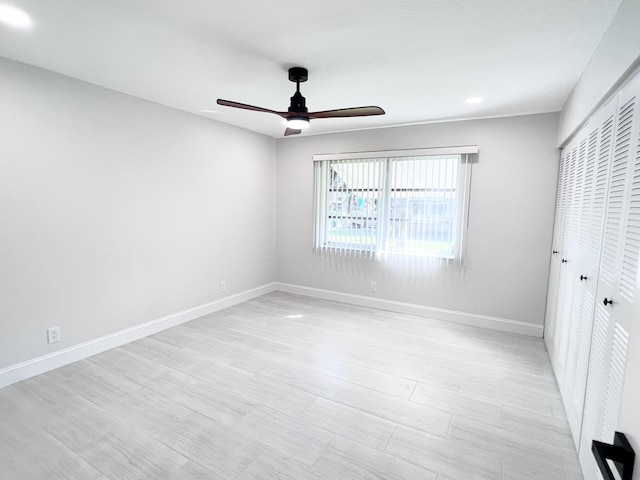 unfurnished bedroom featuring light hardwood / wood-style flooring, a closet, and ceiling fan