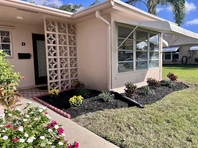 doorway to property with a yard