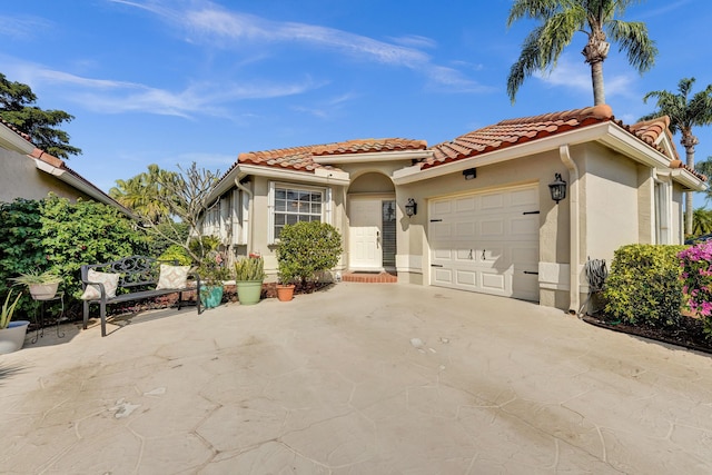 mediterranean / spanish-style house with a garage