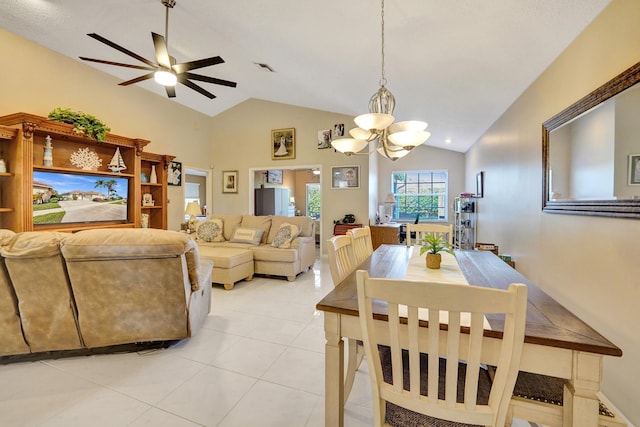 tiled dining space with lofted ceiling and ceiling fan with notable chandelier