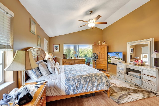 bedroom featuring light hardwood / wood-style flooring, ceiling fan, and vaulted ceiling