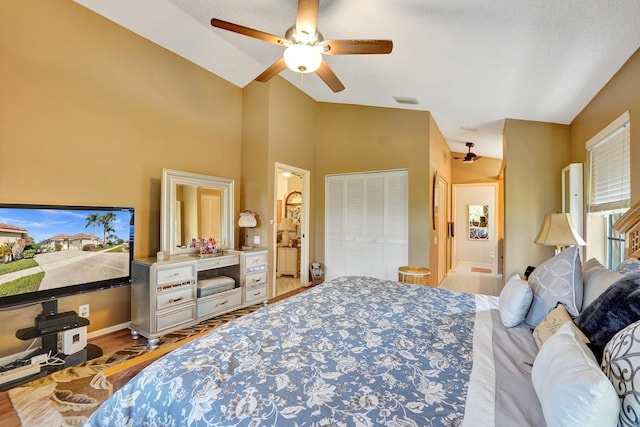 bedroom featuring vaulted ceiling, a closet, ceiling fan, and light hardwood / wood-style flooring