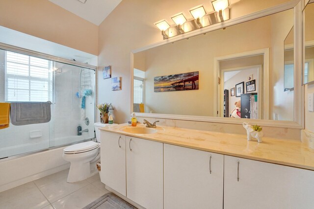 full bathroom featuring toilet, tile patterned floors, shower / bath combination with glass door, and vanity