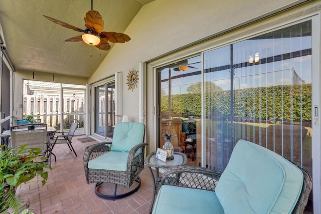 sunroom / solarium with lofted ceiling and ceiling fan