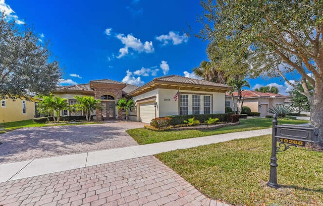 view of front of property featuring a garage and a front lawn