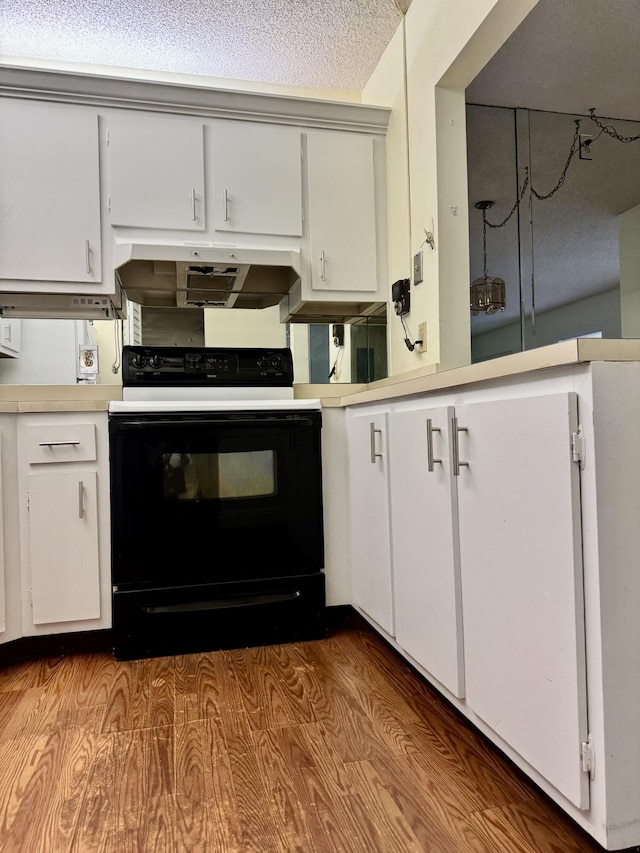 kitchen with white cabinetry, light hardwood / wood-style floors, extractor fan, and electric range oven