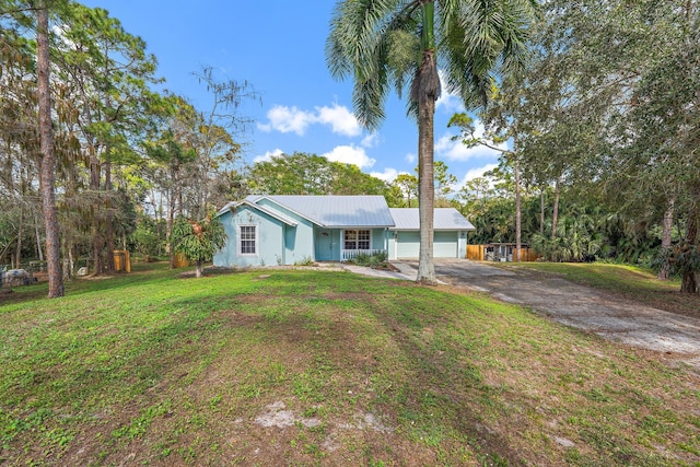 single story home with a garage and a front lawn