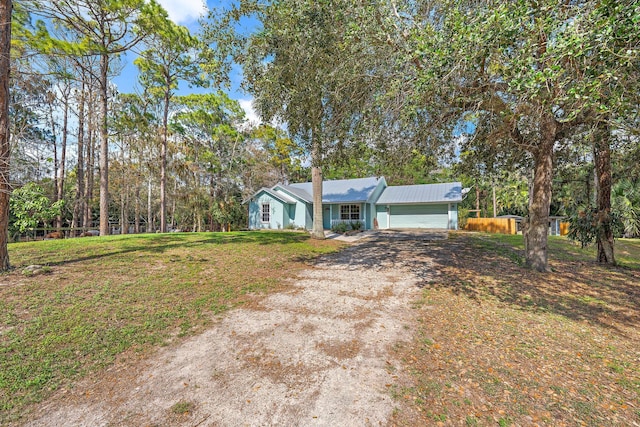 single story home featuring a garage and a front yard