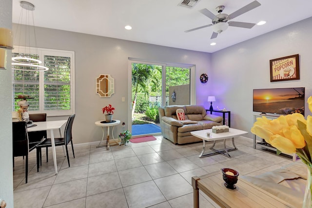 living room featuring ceiling fan and light tile patterned floors