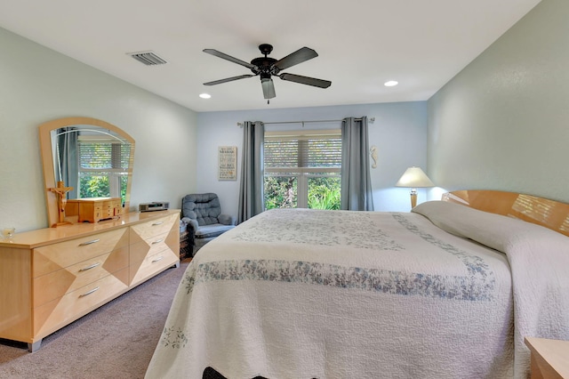 bedroom with ceiling fan and dark colored carpet