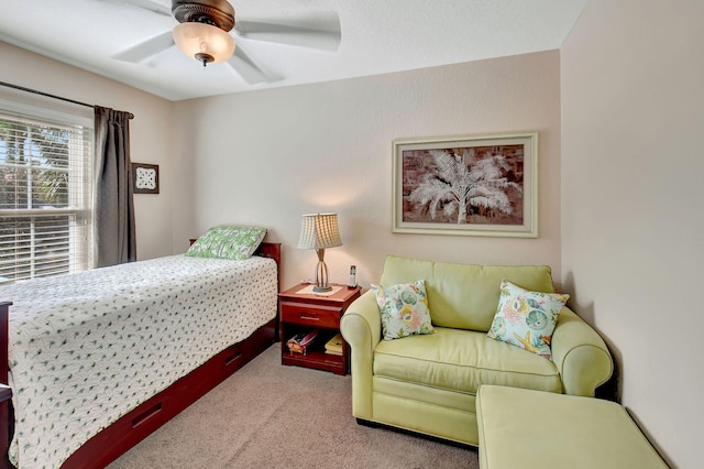 bedroom featuring light colored carpet and ceiling fan