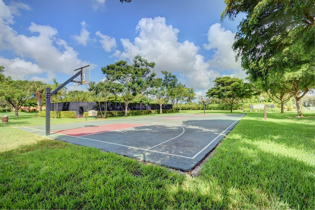 view of sport court featuring a lawn