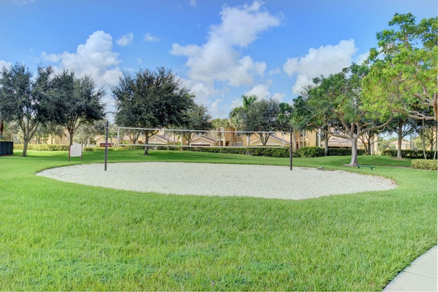 view of property's community with a yard and volleyball court