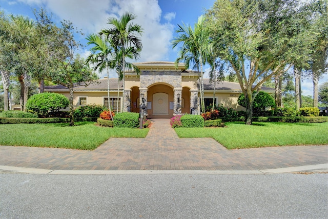 mediterranean / spanish-style home featuring a front yard