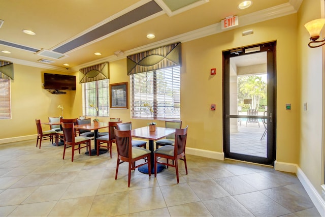 dining area with crown molding and light tile patterned flooring