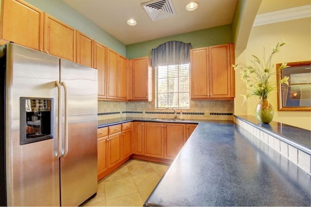 kitchen with tasteful backsplash, stainless steel fridge with ice dispenser, light tile patterned floors, and sink