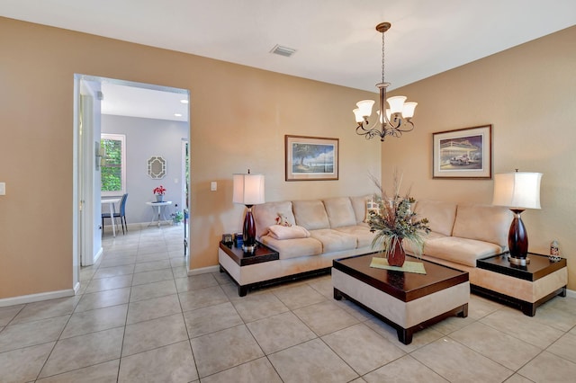 tiled living room with a notable chandelier