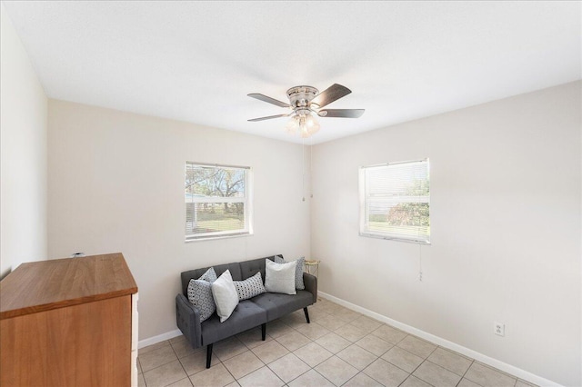 living area featuring light tile patterned floors and ceiling fan