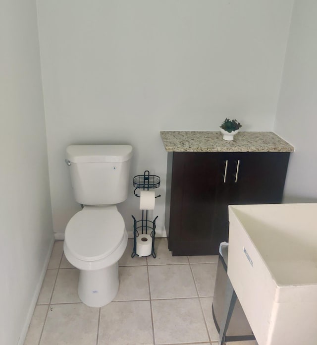 bathroom featuring tile patterned flooring and toilet