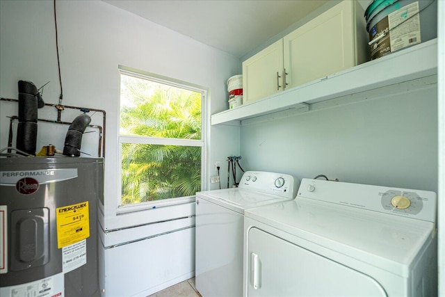 laundry area with washer and dryer, cabinets, and water heater