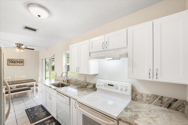 kitchen featuring white cabinetry, sink, white appliances, and light tile patterned floors