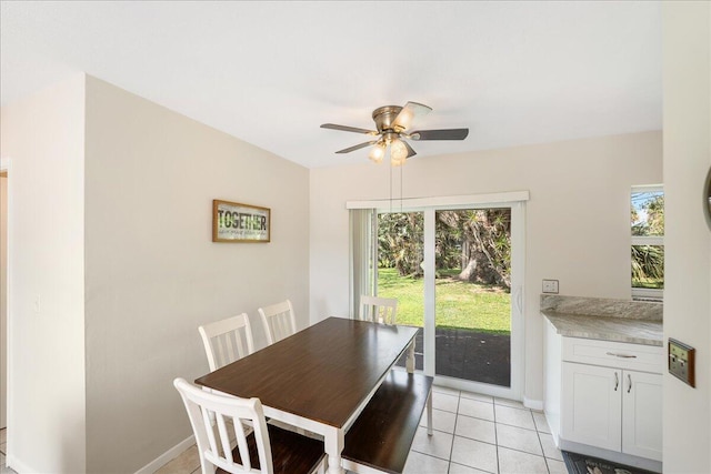 tiled dining area with ceiling fan