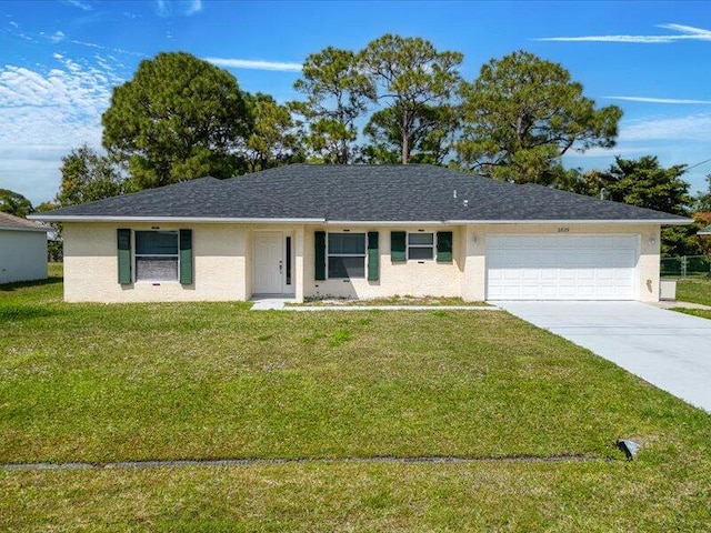 single story home featuring a garage, driveway, a front yard, and stucco siding