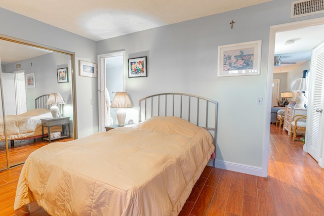 bedroom with hardwood / wood-style flooring and a closet