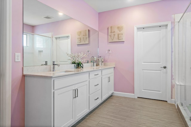 bathroom featuring wood-type flooring, vanity, and walk in shower