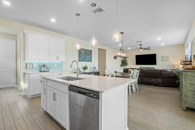 kitchen featuring an island with sink, sink, white cabinets, hanging light fixtures, and stainless steel dishwasher