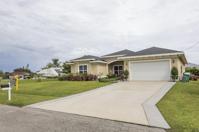 view of front facade featuring a garage and a front lawn