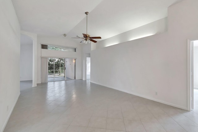 spare room featuring light tile patterned floors, high vaulted ceiling, and ceiling fan