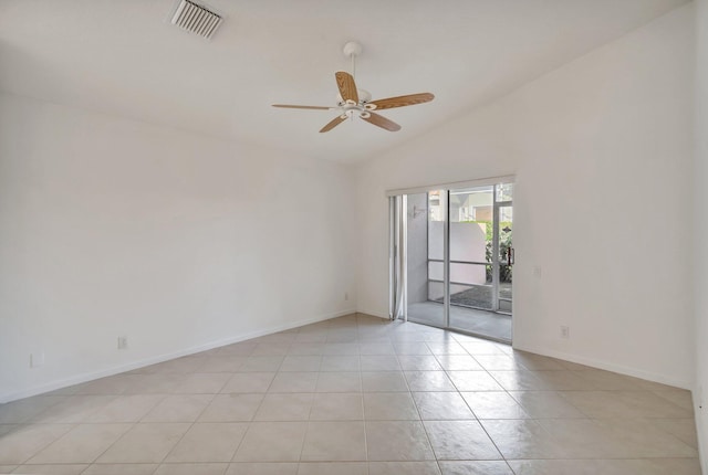 empty room with light tile patterned floors, vaulted ceiling, and ceiling fan