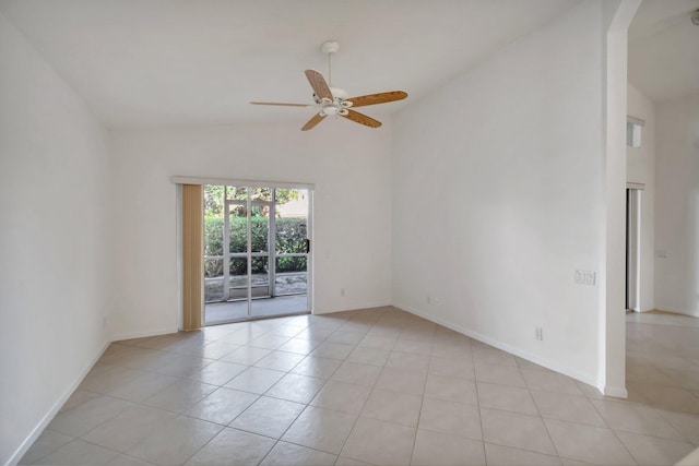 spare room with arched walkways, light tile patterned floors, a ceiling fan, high vaulted ceiling, and baseboards