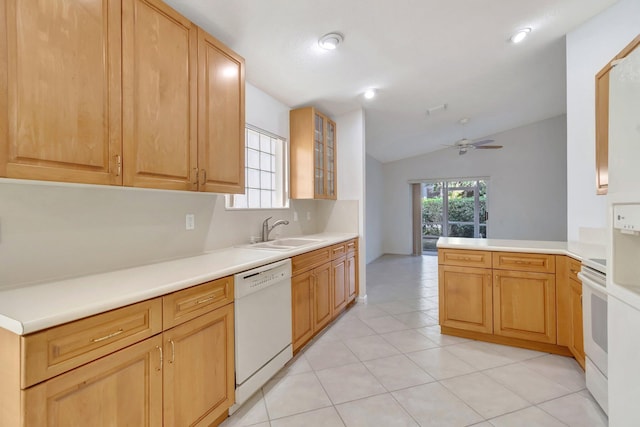 kitchen featuring light countertops, glass insert cabinets, a sink, white appliances, and a peninsula