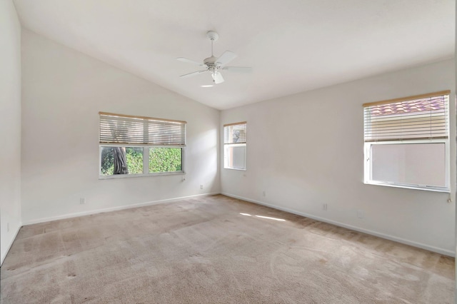 carpeted empty room with ceiling fan and vaulted ceiling