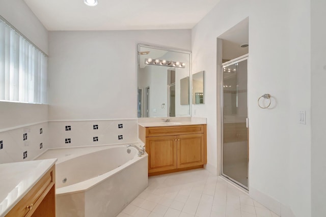 full bathroom featuring tile patterned flooring, a garden tub, vanity, and a shower stall